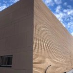 Façade moderne en bois sous ciel bleu.